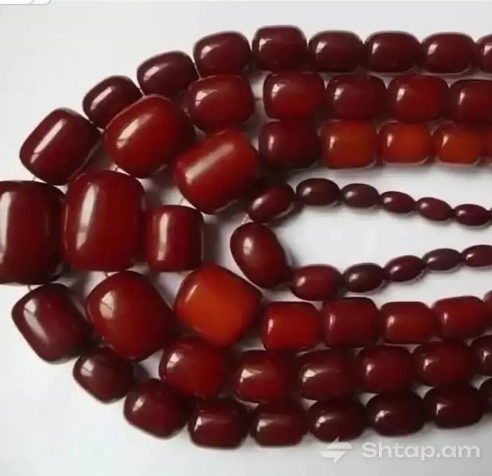 Dark Red Pearls on a White Surface 0