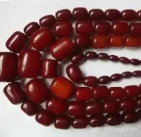 Dark Red Pearls on a White Surface image thumbnail 0